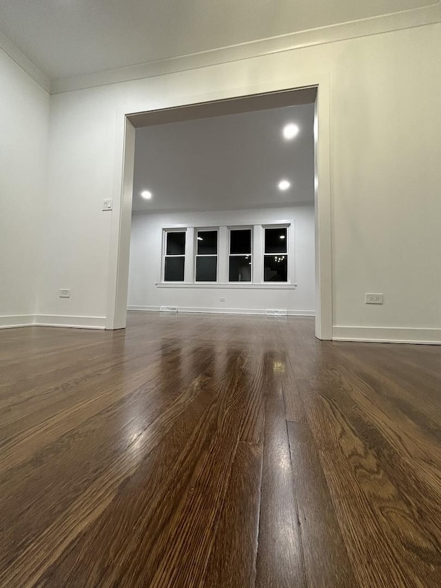 interior space with baseboards, ornamental molding, recessed lighting, and wood finished floors