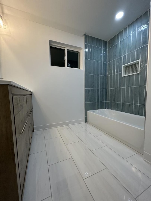 bathroom featuring baseboards, marble finish floor, recessed lighting, and tub / shower combination