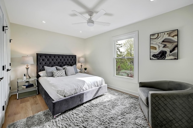 bedroom with light wood-style floors, baseboards, and recessed lighting