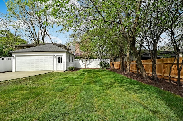 view of yard featuring a fenced backyard and a detached garage