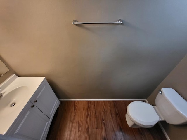 200 Rodenburg Rd, Roselle, IL 60172 - bathroom with baseboards, wood finished floors, toilet, and vanity