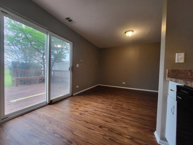 200 Rodenburg Rd, Roselle, IL 60172 - unfurnished dining area with baseboards, visible vents, and dark wood-style floors