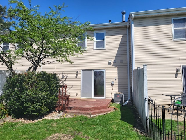 200 Rodenburg Rd, Roselle, IL 60172 - rear view of house with a lawn, a deck, fence, and central AC unit