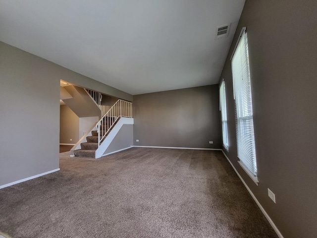200 Rodenburg Rd, Roselle, IL 60172 - unfurnished living room featuring carpet floors, stairs, baseboards, and visible vents