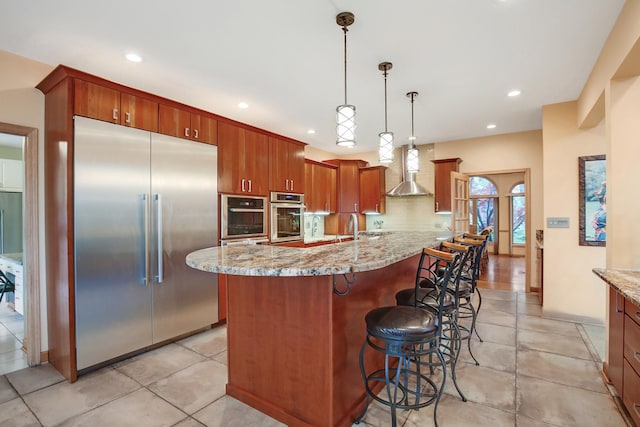 1730 Cambridge Ave, Flossmoor, IL 60422 - kitchen with light stone counters, stainless steel appliances, recessed lighting, and wall chimney exhaust hood