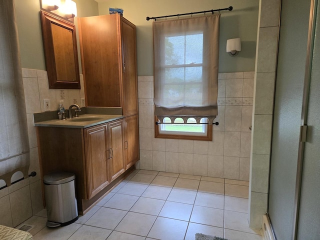 full bathroom featuring tile walls, tile patterned flooring, and a wealth of natural light