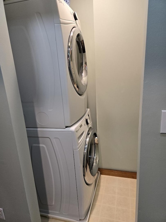 laundry area featuring stacked washing maching and dryer and laundry area