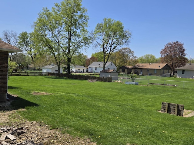 view of yard featuring fence and a residential view