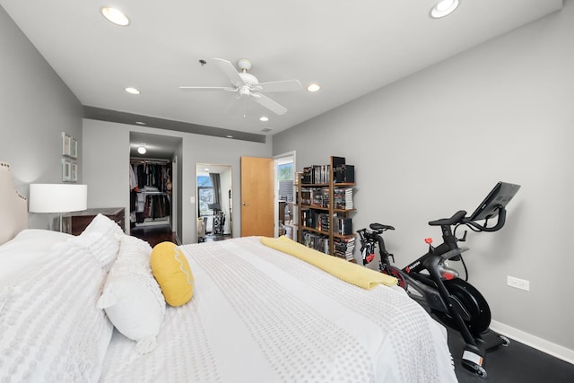 bedroom with a closet, baseboards, a walk in closet, and recessed lighting