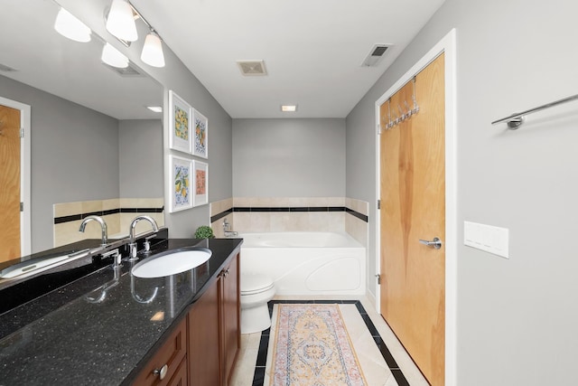 full bath featuring vanity, toilet, a garden tub, and visible vents