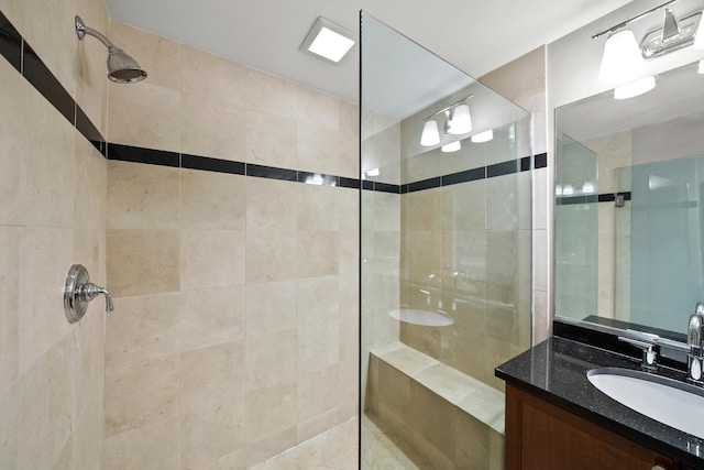 full bathroom with walk in shower and vanity