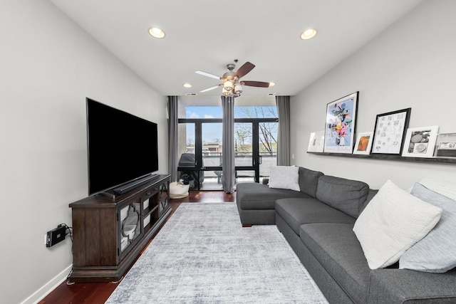 living room with dark wood-style flooring, baseboards, ceiling fan, and recessed lighting