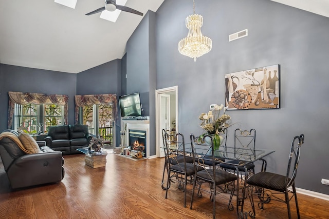 454 Kilkenny Ct Unit 454, Carol Stream, IL 60188 - dining area featuring high vaulted ceiling, ceiling fan, wood finished floors, a chandelier, and a warm lit fireplace