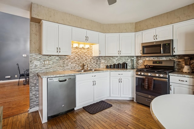 454 Kilkenny Ct Unit 454, Carol Stream, IL 60188 - kitchen featuring appliances with stainless steel finishes, a sink, white cabinetry, wood-type flooring, and decorative backsplash