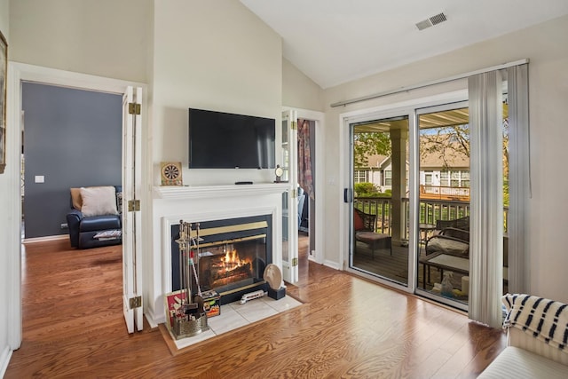 454 Kilkenny Ct Unit 454, Carol Stream, IL 60188 - living room with wood finished floors, a fireplace with flush hearth, baseboards, and high vaulted ceiling
