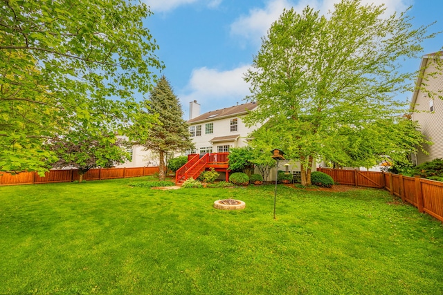 view of yard featuring a fire pit, stairway, and a deck