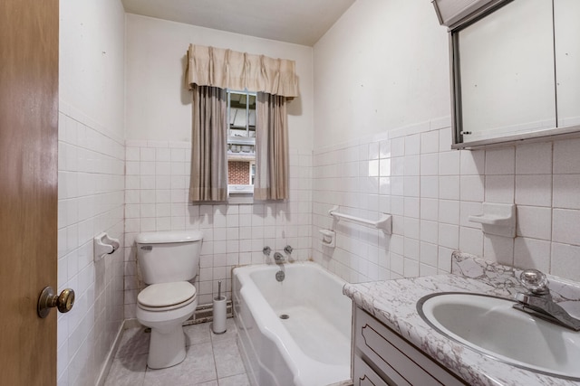 bathroom with a bath, tile walls, tile patterned floors, vanity, and toilet