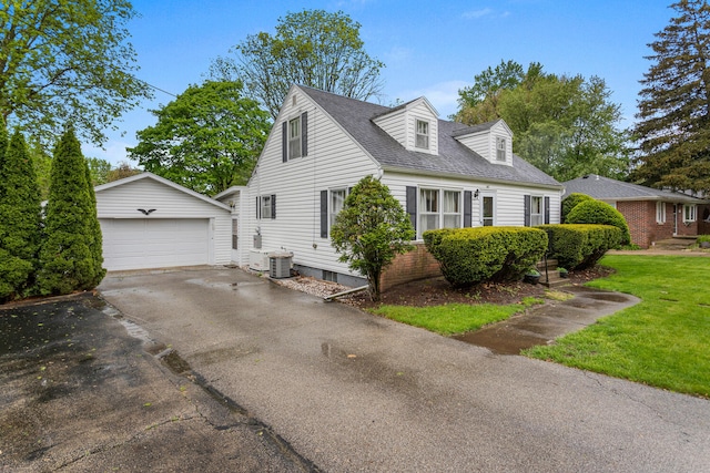 view of side of home featuring a lawn, cooling unit, an outdoor structure, and a garage
