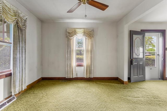 unfurnished room featuring visible vents, carpet, and a healthy amount of sunlight