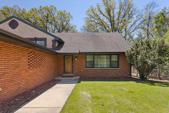 33 Half Day Rd, Lincolnshire, IL 60069 - view of front of home featuring brick siding, a front yard, and a shingled roof