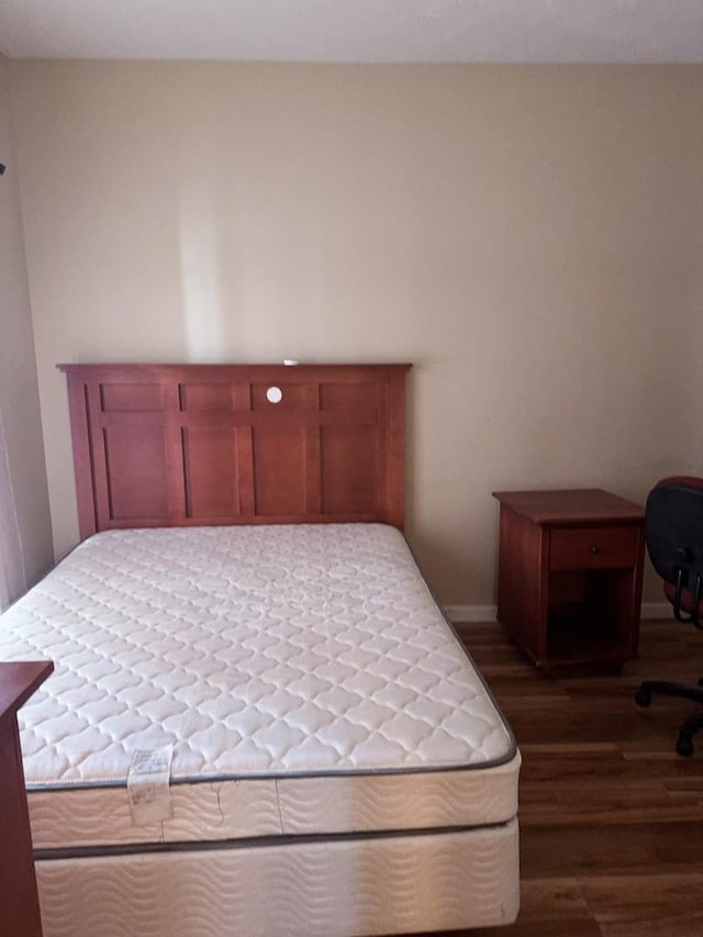 bedroom with dark wood-style floors