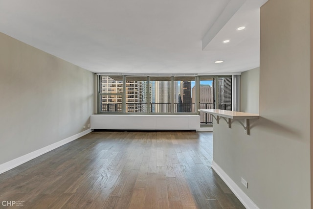 400 E Randolph St Unit 3428, Chicago, IL 60601 - empty room with dark wood-style flooring, baseboards, and recessed lighting