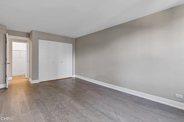 400 E Randolph St Unit 3428, Chicago, IL 60601 - unfurnished bedroom featuring baseboards, a closet, and wood finished floors