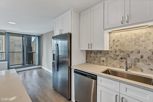 400 E Randolph St Unit 3428, Chicago, IL 60601 - kitchen with wood finished floors, white cabinets, tasteful backsplash, a sink, and appliances with stainless steel finishes