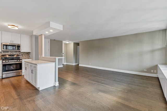400 E Randolph St Unit 3428, Chicago, IL 60601 - kitchen with appliances with stainless steel finishes, light countertops, dark wood finished floors, open floor plan, and backsplash