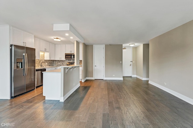 400 E Randolph St Unit 3428, Chicago, IL 60601 - kitchen with a breakfast bar area, white cabinetry, backsplash, light countertops, and appliances with stainless steel finishes
