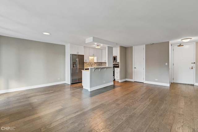 400 E Randolph St Unit 3428, Chicago, IL 60601 - unfurnished living room featuring recessed lighting, baseboards, and wood finished floors