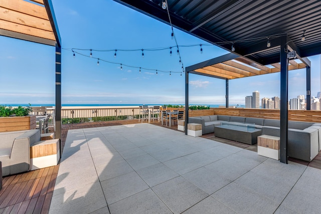 view of patio / terrace featuring a water view and an outdoor living space