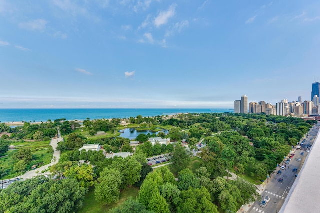 drone / aerial view featuring a view of city and a water view