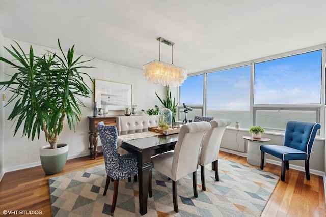 5733 N Sheridan Rd Unit 29D, Chicago, IL 60660 - dining area with light wood-type flooring, a chandelier, and healthy amount of natural light