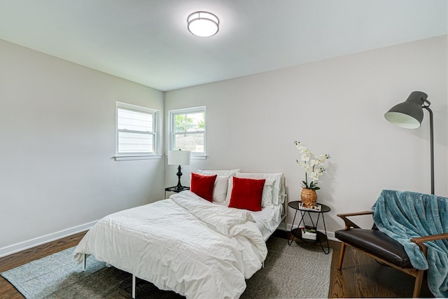 bedroom featuring baseboards and wood finished floors