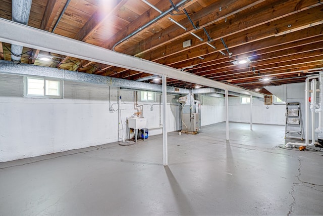 below grade area with plenty of natural light, a sink, and heating unit