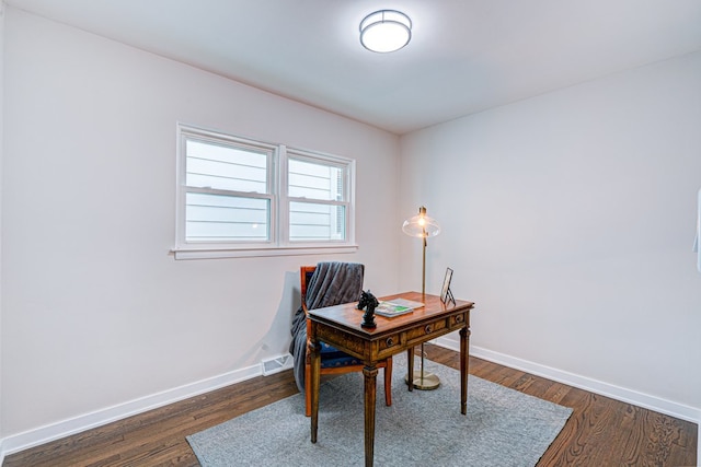 office space with dark wood-style flooring and baseboards