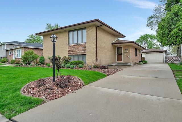 view of front of house featuring brick siding, an outdoor structure, a detached garage, concrete driveway, and a front yard