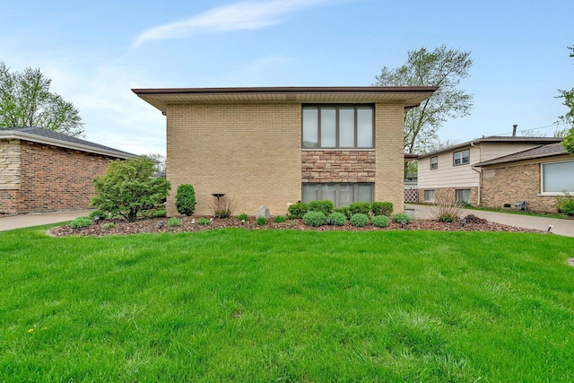 exterior space with a lawn and brick siding