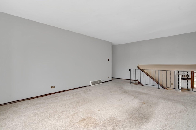 carpeted spare room with baseboards and visible vents