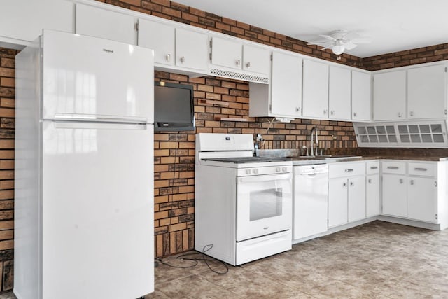 kitchen featuring a sink, dark countertops, white cabinets, ceiling fan, and white appliances