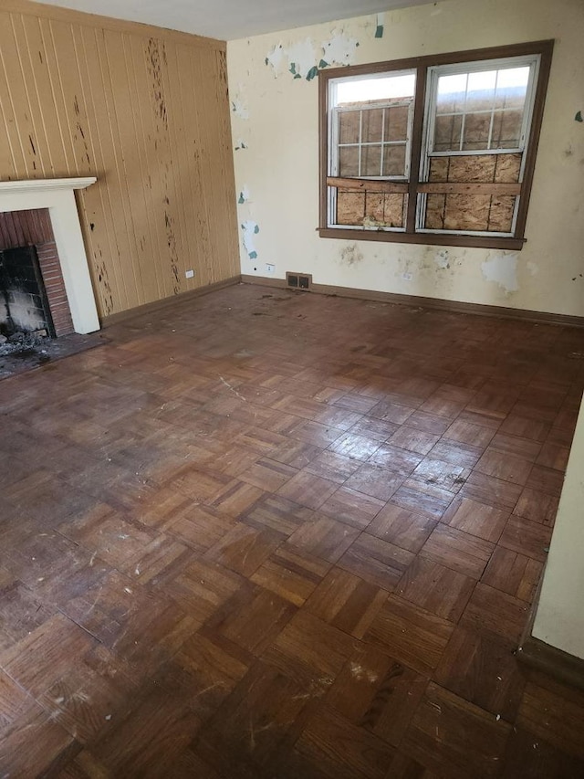 14201 S Wentworth Ave, Riverdale, IL 60827 - unfurnished living room with baseboards, plenty of natural light, a fireplace, and visible vents