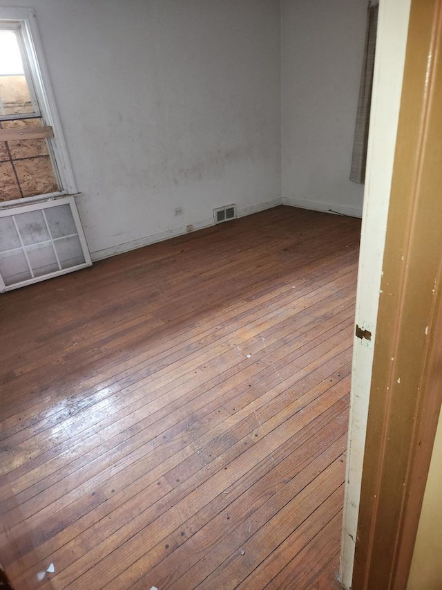 14201 S Wentworth Ave, Riverdale, IL 60827 - spare room with visible vents and hardwood / wood-style floors