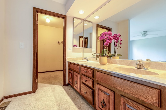 full bathroom with a sink, baseboards, and double vanity