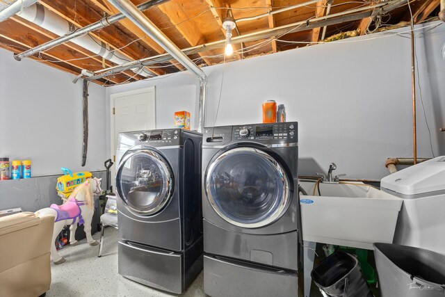 washroom with washing machine and clothes dryer