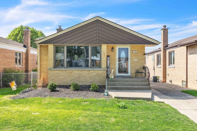view of front of property featuring brick siding and central AC