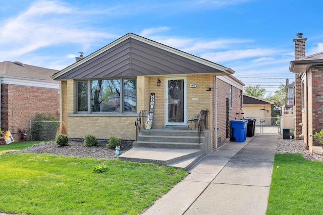 view of front of property featuring brick siding and a gate