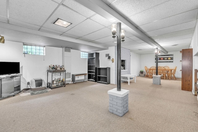 below grade area featuring carpet and a drop ceiling