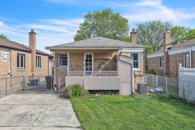 view of front of property featuring a gate, cooling unit, brick siding, and a chimney