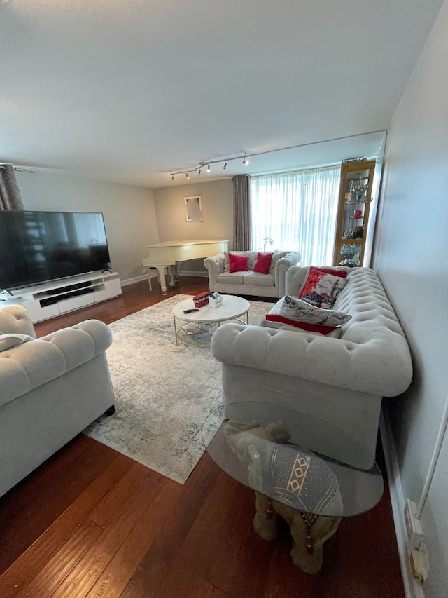 living room with baseboards and wood finished floors